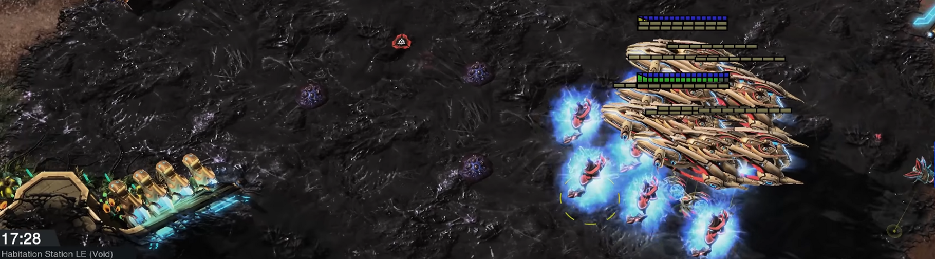 A clumped up army of Protoss units composed of Carriers, Archons, and Sentries moving on Zerg creep